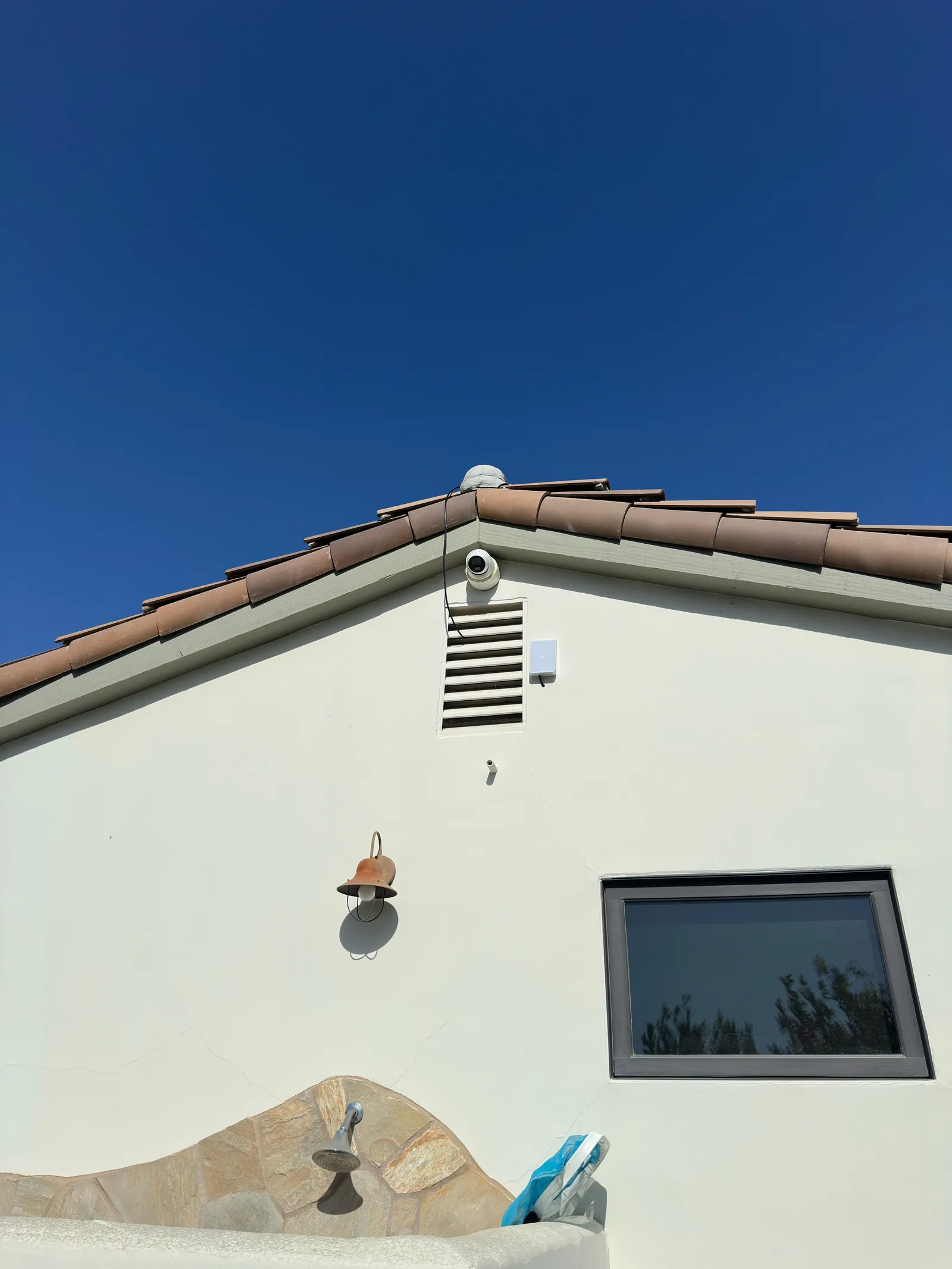 Security camera professionally installed under the roof eave of a senior's Orange County home